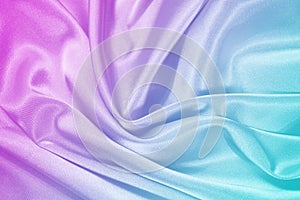 Pink tuquoise silk satin. Gradient. Wavy folds. Shiny fabric surface. Beautiful purple teal background photo