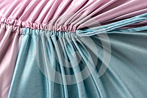 Pink and turquoise color stitched frilly cloth. photo