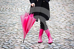 Pink umbrella and pink rubber boots