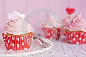 Pink Valentine cupcakes on a rustic table