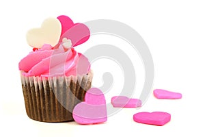 Pink Valentines Day cupcake with candy hearts