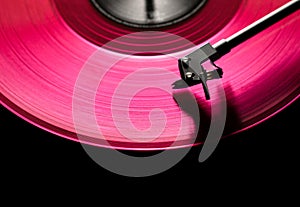 Pink vinyl disc. close-up. techno music. black background,