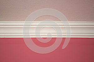 Pink wall section between wall and ceiling and foam cornice molding
