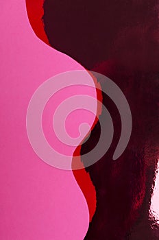 Pink wavy paper on the shine red background. Abstract background for design.Empty space photo