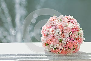 Pink wedding bouquet the bride on background of the fountain