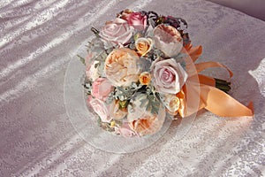 Pink wedding bouquet with orange bow