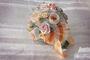 Pink wedding bouquet with orange bow