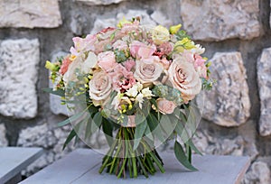 Pink wedding bouquet of various flowers and eucalyptus