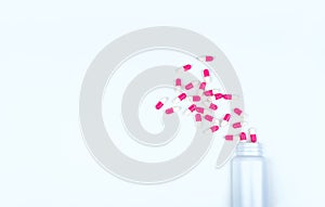 Pink-white antibiotic capsule pills spread out of white plastic drug bottle. Antibiotic drug resistance concept. Antibiotic drug u