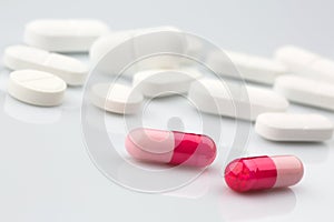 Pink and white antibiotic pills.