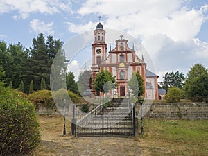 Pink and white baroque church of saint Mary Magdalene in Marenice, Czech Republic, sunny summer day, vibrant color