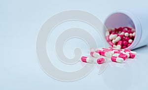 Pink-white capsule pills spread out of drug bottle. Antipsychotic drug. Capsule medicine for treatment depression. Anti-anxiety