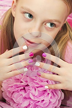 Pink white children`s manicure.