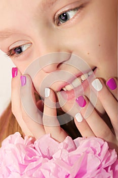 Pink white children`s manicure.