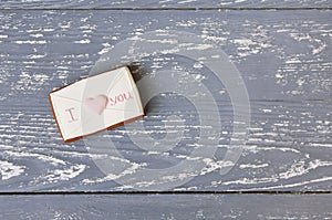 Pink and white cookie on wooden background with copy space