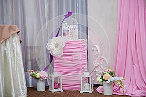 Pink and white decorations with flowers, lanterns and bird cage for birthday or wedding party