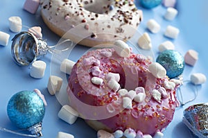 Pink and white donuts with marshmallows with christmas decorations
