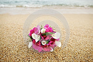 Pink and white flower wedding bouquet on the beach