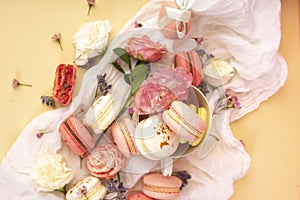 Pink and white macaroons cakes with big and small flower buds ar