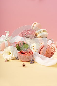 Pink and white macaroons cakes with big and small flower buds ar