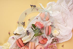 Pink and white macaroons cakes with big and small flower buds ar