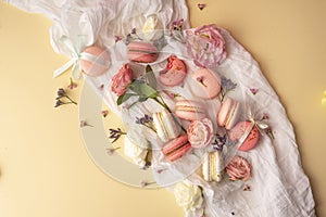 Pink and white macaroons cakes with big and small flower buds ar