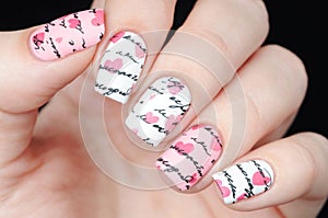 Pink white manicure on St. Valentine s Day with pattern words letter and hearts