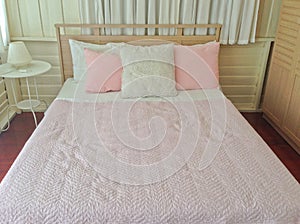 Pink and white pillow, pink blanket in wood bedroom sweet interior