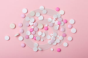 Pink and white pills on pink background. Heap of assorted various medicine tablets and pills. Horizontal banner