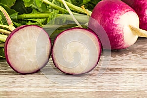 Pink and white radish close and cut on the board