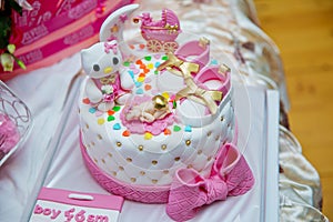Pink and white theme cake for baby . newborn boy birthday cake . Children`s shoes . It`s a boy baby shower cake