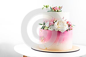 Pink and white wedding bunk cake with fresh flowers decoration