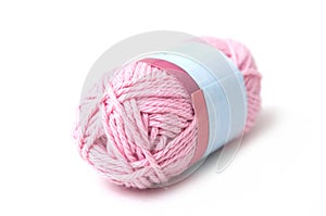 Pink wool bobin on white background