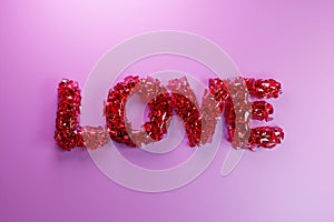 The pink word LOVE explodes into a small particles.