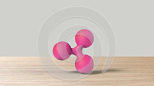 Pink xrp ripple gold sign icon on wood table white background. 3d render isolated illustration, cryptocurrency, crypto, business,