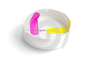 Pink and yellow band-aid sticked on white ashtray