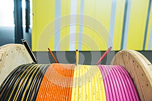 Pink, Yellow, Orange and Black Coated Cables on Wood Reel