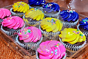 Pink, yellow and purple cupcakes ready for the party.