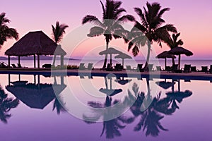 Pinkish purple sunrise colors reflecting in the water in Fiji