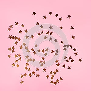 Pinky holiday background with scattered golden stars