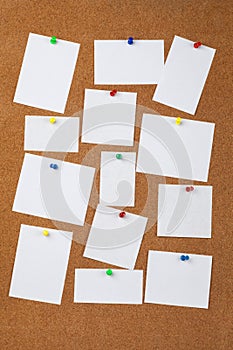 Pinned blank paper notes on background