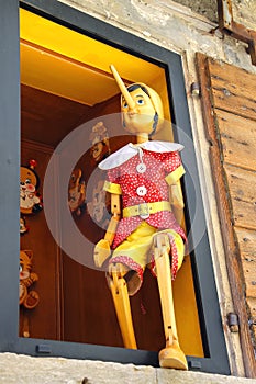 Pinocchio in the window building store of wooden toys