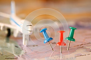 Pins attached to map, showing location or travel destination . retro style image. selective focus.