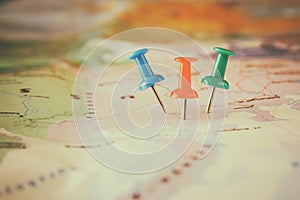 Pins attached to map, showing location or travel destination . retro style image. selective focus.