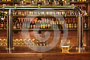 Pint of beer on a bar in a traditional style pub photo