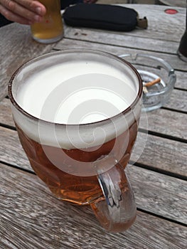 Pint of beer on bench table