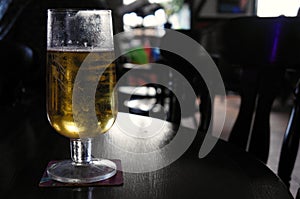 A pint of beer with soft focus background