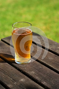 Pint of cider on pub bench