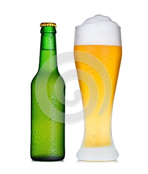 Pint glass of beer and bottle in dew