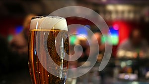 Pint glass of lager on pub table